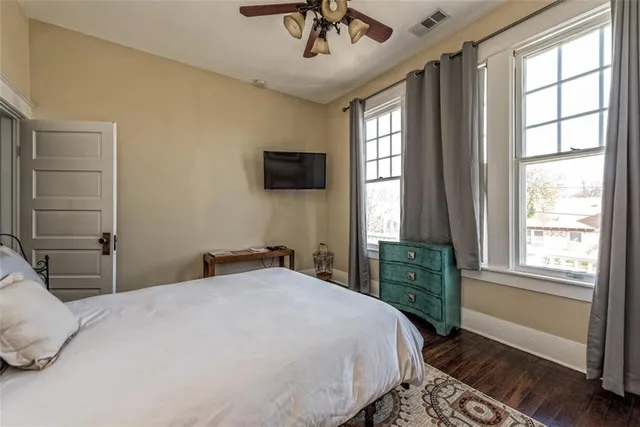a bedroom with a large bed and a window