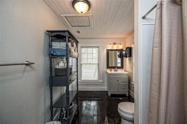 a bathroom with a toilet sink and mirror