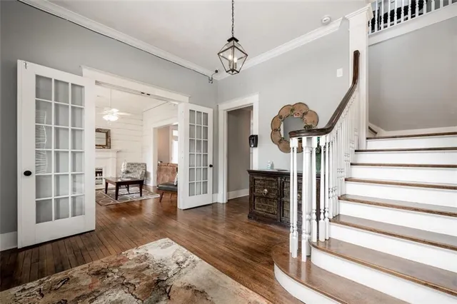a view of a livingroom with furniture wooden floor and a chandelier