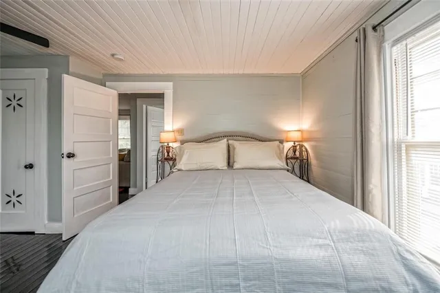 a bedroom with a large bed and a window