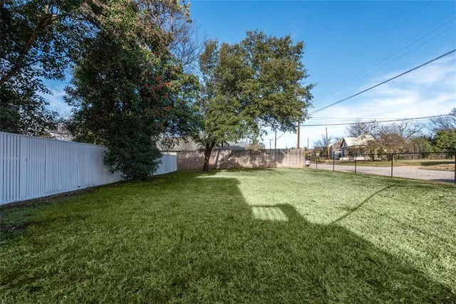 a view of yard with swimming pool and trees