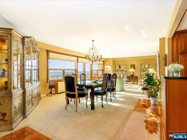 a dining room with furniture water view and large windows