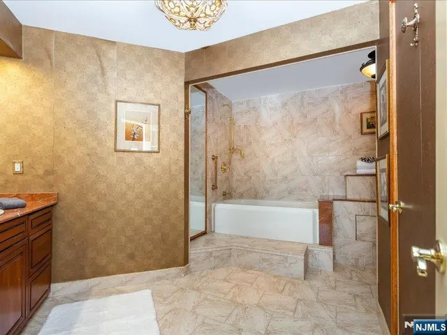 a bathroom with a bathtub and a shower
