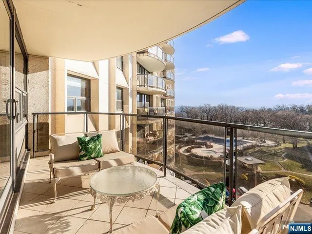 a balcony with table and chairs potted plants with wooden floor