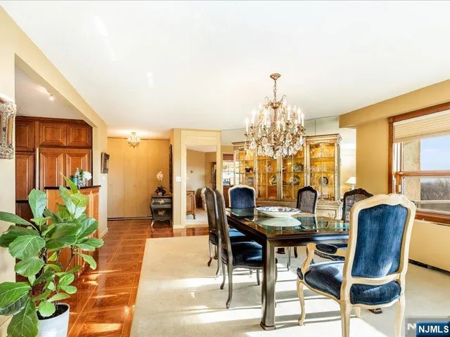 a view of a dining room with furniture and a chandelier