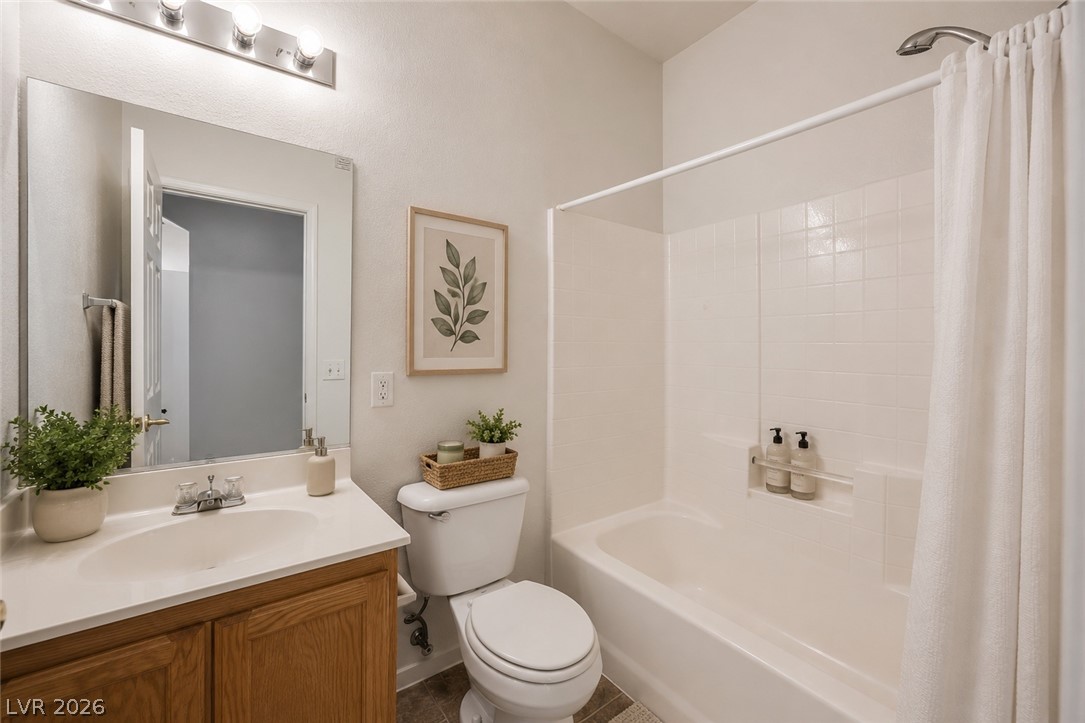 6320 Snap Ridge Street, Unit 201 North Las Vegas, NV 89081 - Photo 12 of 56 A well-appointed bathroom offers a clean vanity, bright mirror, and a bathtub with shower.