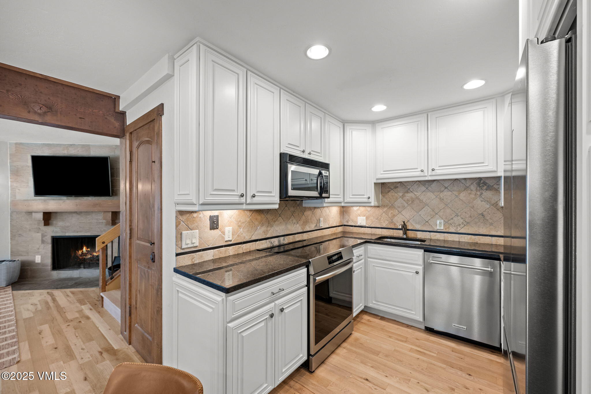 4770 Big Horn Road, Unit B4 Vail, CO 81657 - Photo 12 of 47 a kitchen with stainless steel appliances granite countertop a stove top oven a sink and a refrigerator