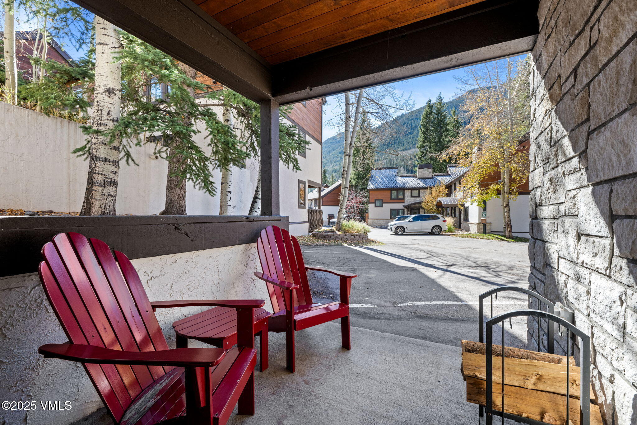 4770 Big Horn Road, Unit B4 Vail, CO 81657 - Photo 27 of 47 a view of a patio with a table chairs and a floor to ceiling window