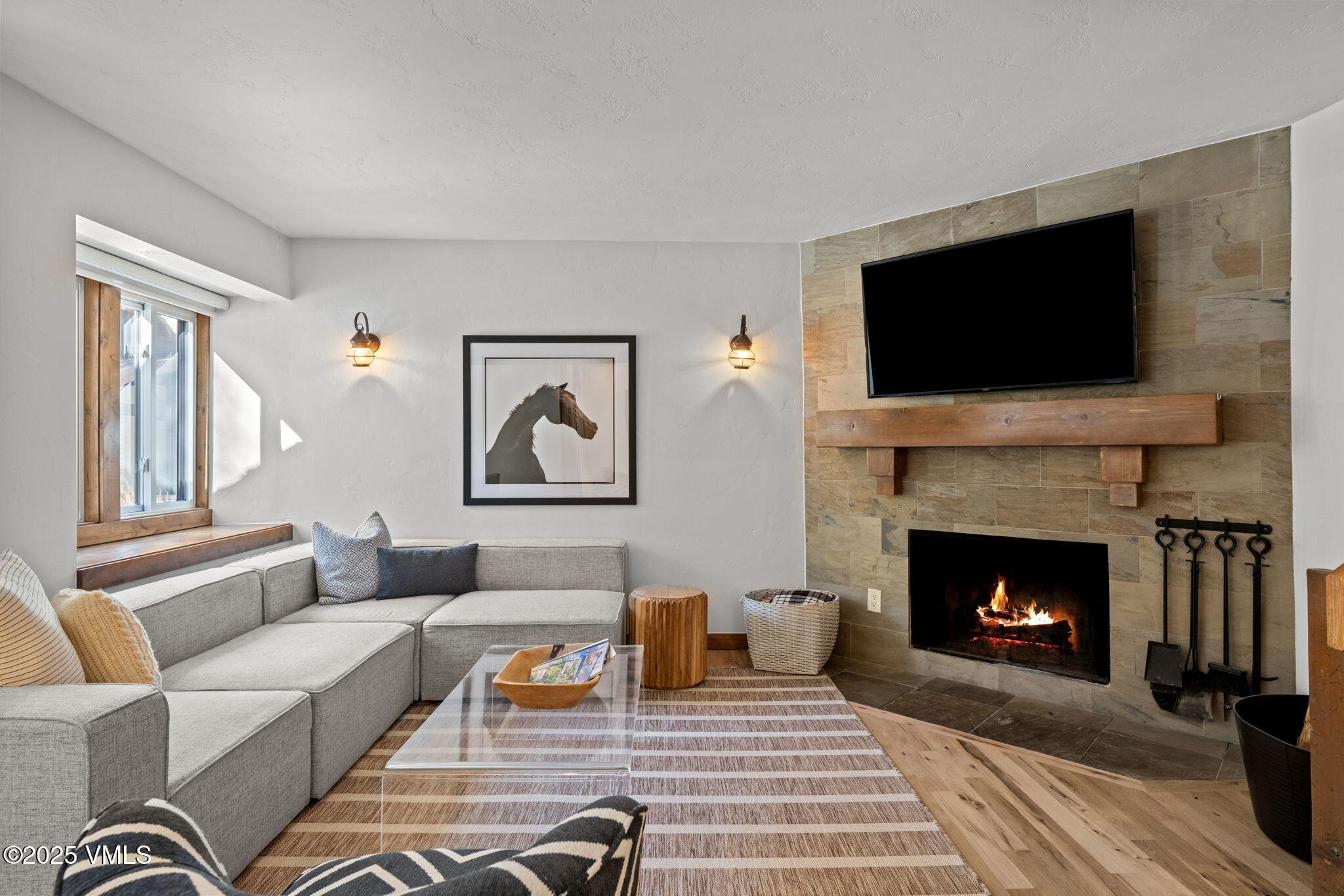 4770 Big Horn Road, Unit B4 Vail, CO 81657 - Photo 6 of 47 a living room with furniture a flat screen tv and a fireplace