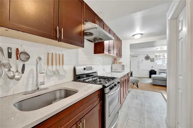 a kitchen with stainless steel appliances a sink a stove and a refrigerator