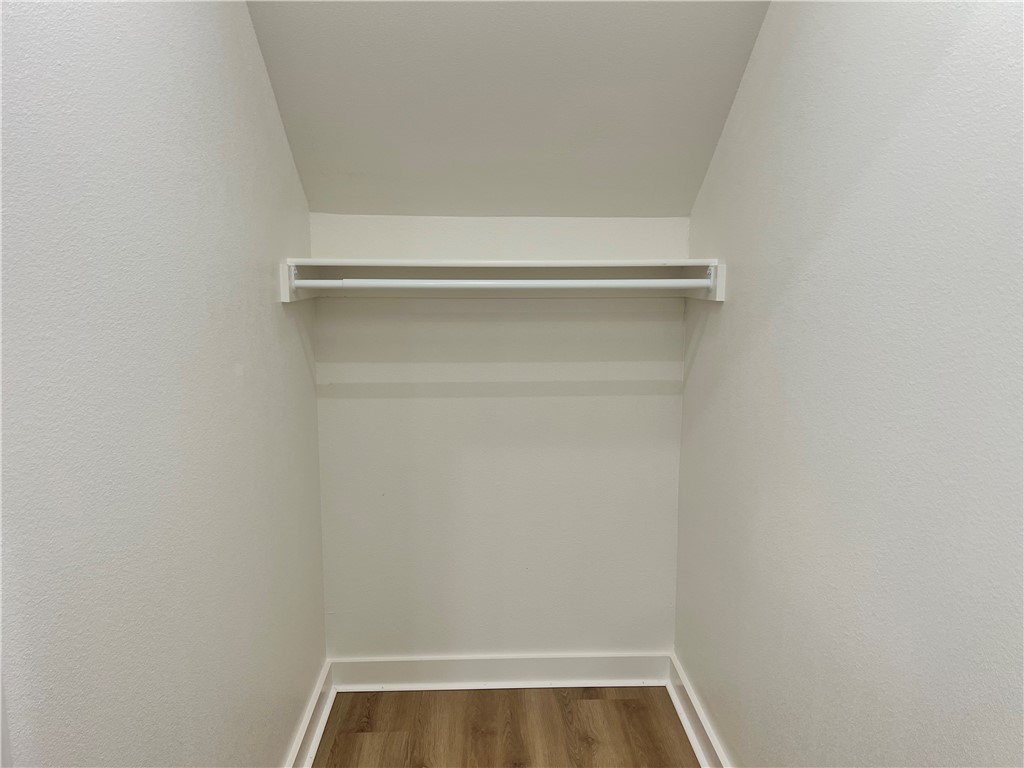 1715 Cuppett Circle Pea Ridge, AR 72751 - Photo 13 of 15 Recessed closet space with a single hanging rod, upper shelf, wood-finish flooring, and crisp white trim