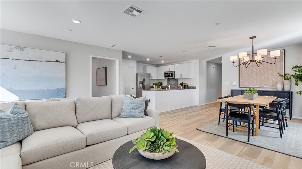 14193 Clemson Street Hesperia, CA 92344 - Photo 1 of 21 a living room with furniture kitchen view and a dining table