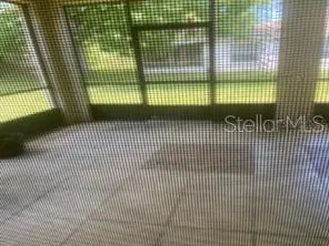 a bedroom with a bed next to a window