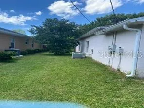 a backyard of a house with table and chairs