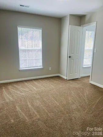 an empty room with a empty space and windows