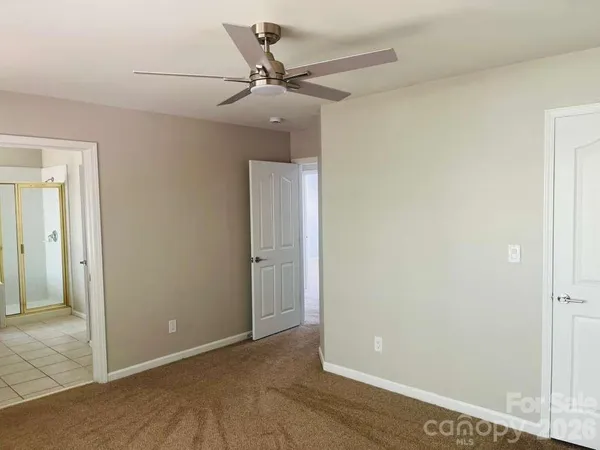 a view of a livingroom with a ceiling fan and window