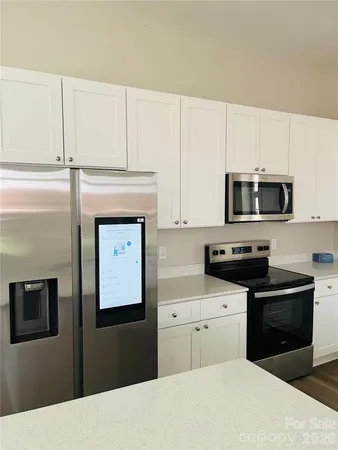 a kitchen with stainless steel appliances a stove microwave and cabinets