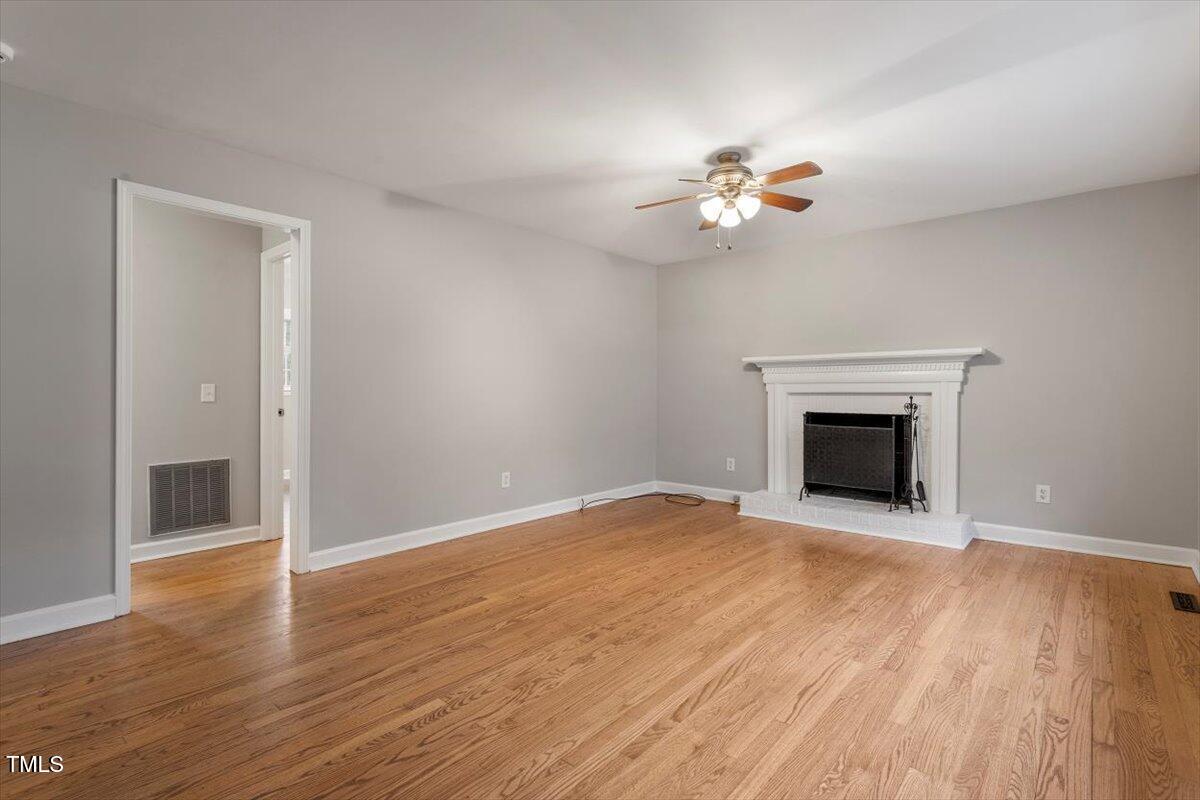 3402 Pat Tilley Road Bahama, NC 27503 - Photo 10 of 32 wooden floor with chandelier fan in white room