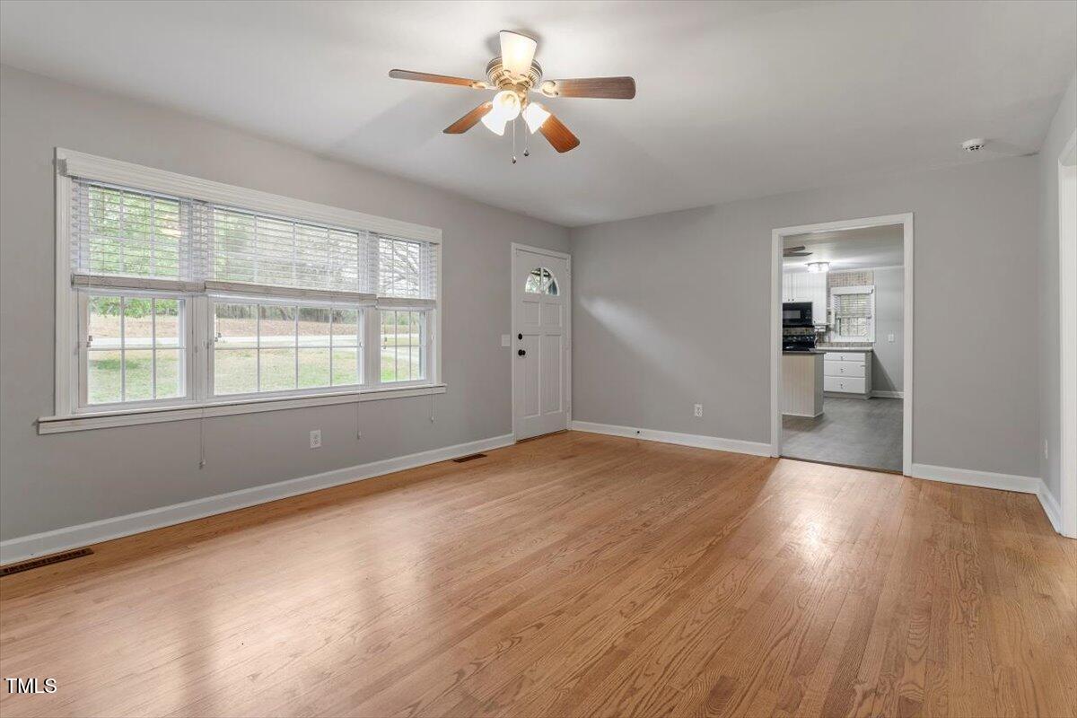 3402 Pat Tilley Road Bahama, NC 27503 - Photo 12 of 32 a view of empty room with wooden floor and fan