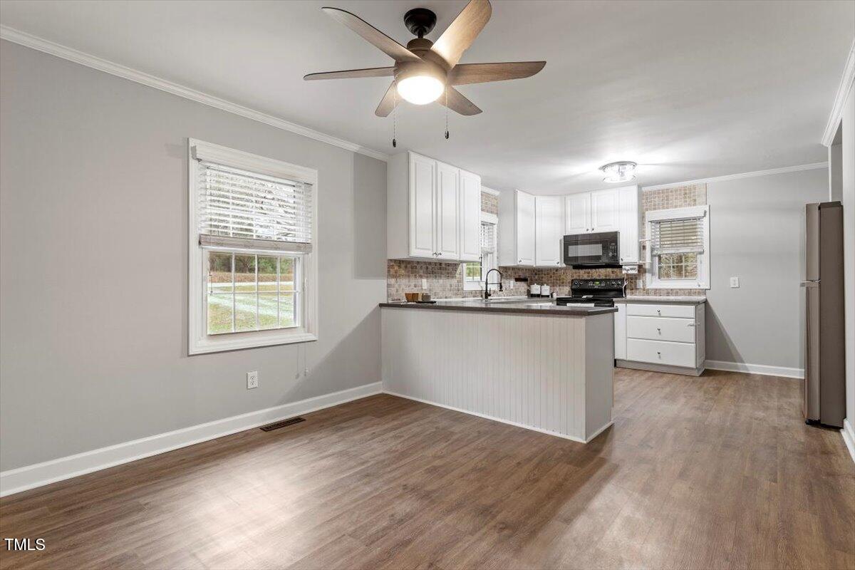 3402 Pat Tilley Road Bahama, NC 27503 - Photo 15 of 32 a kitchen with a refrigerator and window