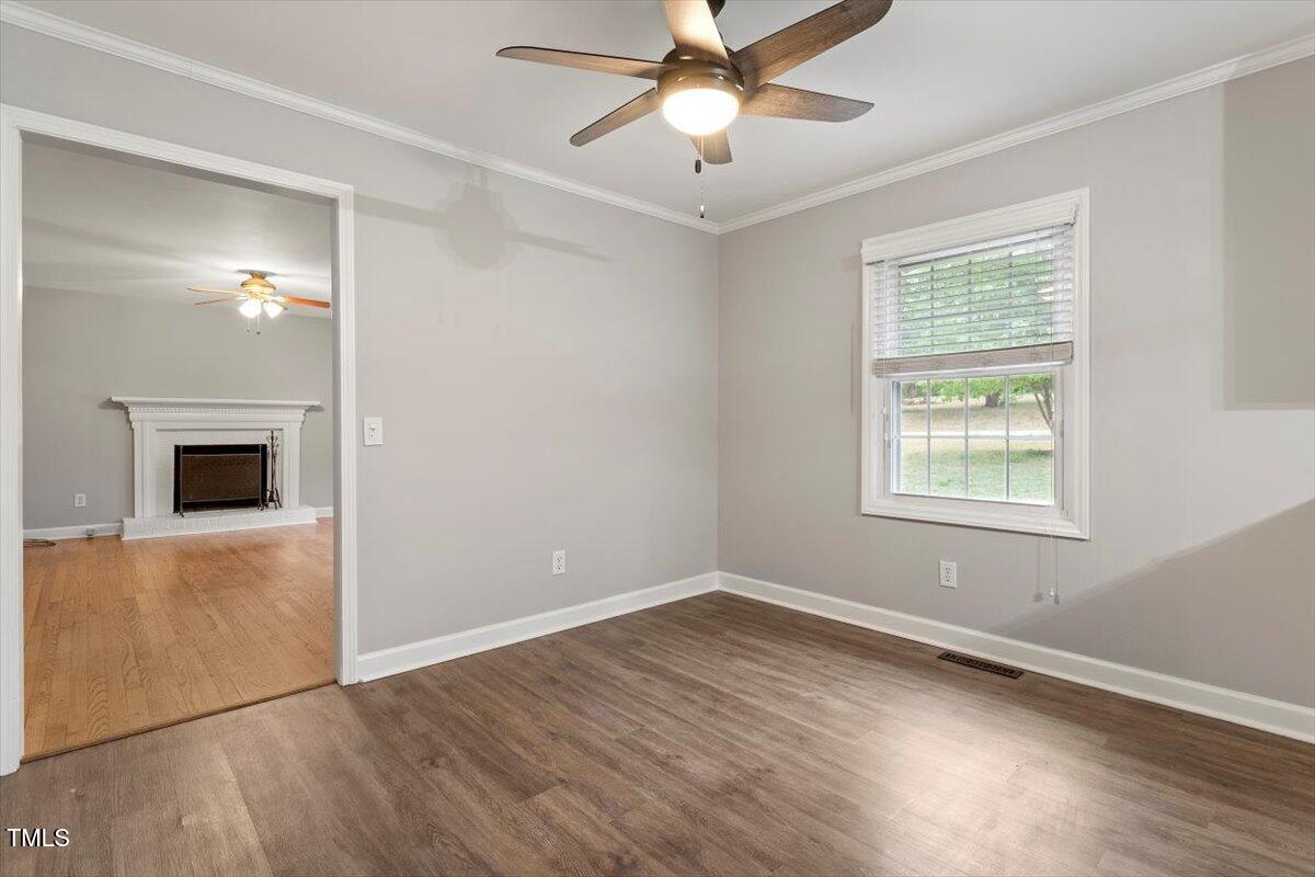 3402 Pat Tilley Road Bahama, NC 27503 - Photo 16 of 32 a view of an empty room with wooden floor and a window