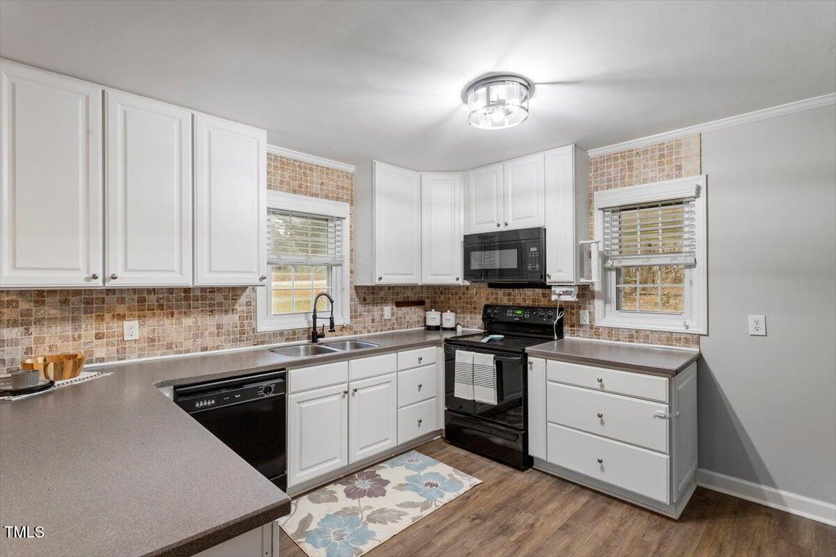 3402 Pat Tilley Road Bahama, NC 27503 - Photo 17 of 32 a kitchen with a sink stove and microwave