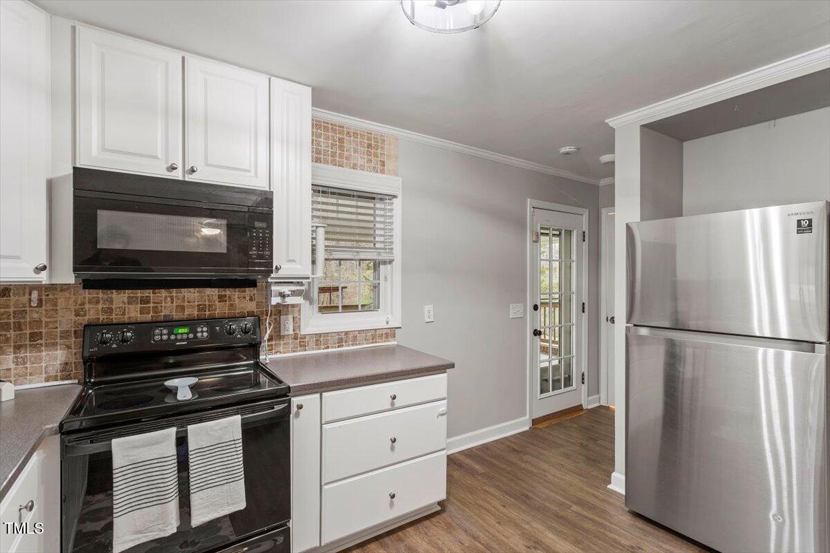 3402 Pat Tilley Road Bahama, NC 27503 - Photo 20 of 32 a kitchen with granite countertop a refrigerator stove and microwave