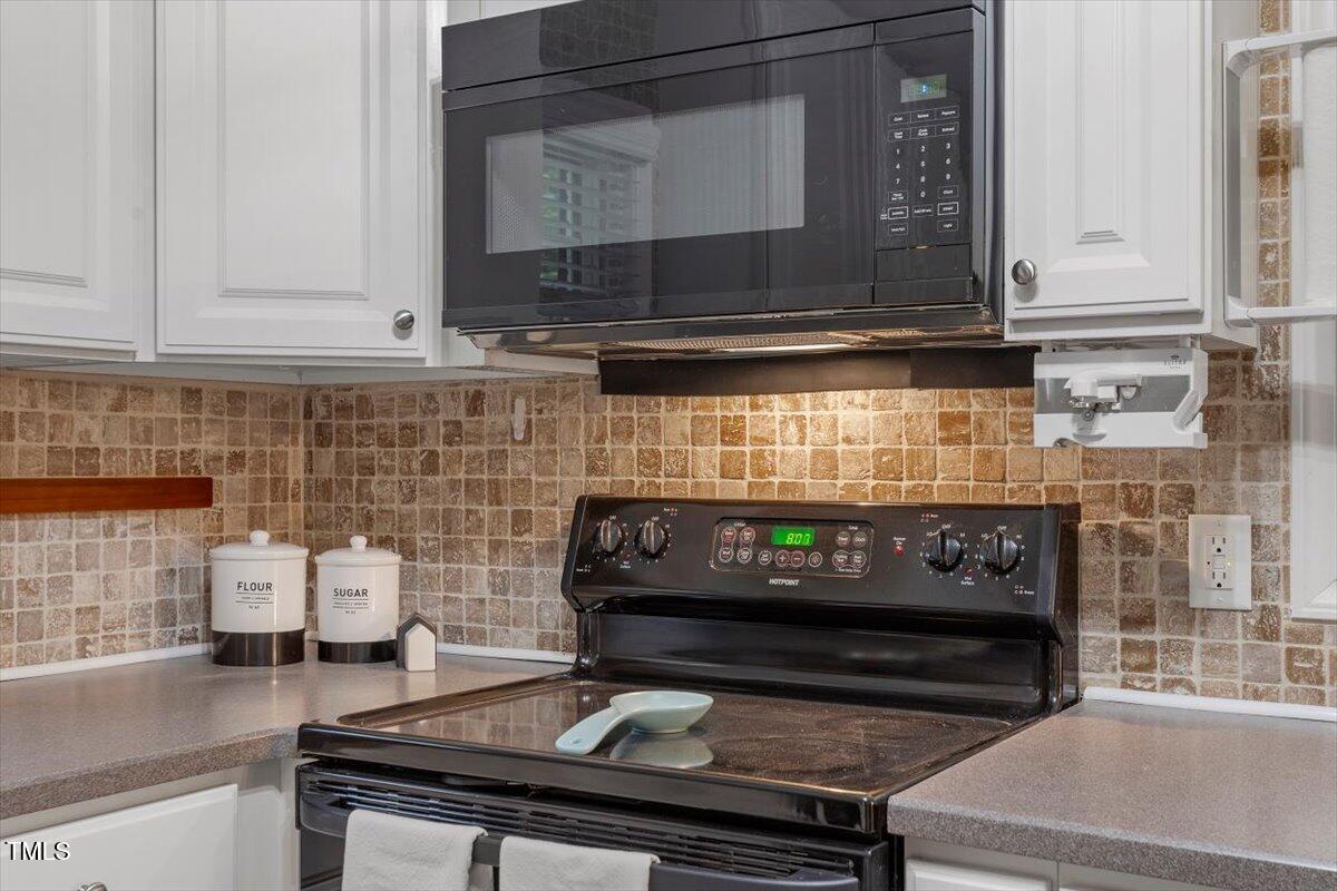 3402 Pat Tilley Road Bahama, NC 27503 - Photo 22 of 32 a kitchen with a stove and a microwave