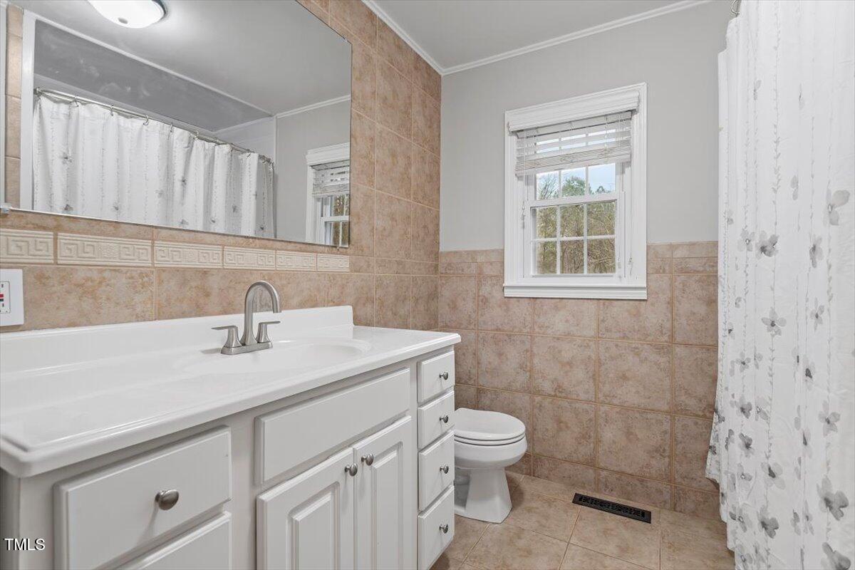 3402 Pat Tilley Road Bahama, NC 27503 - Photo 25 of 32 a bathroom with a sink a toilet and shower