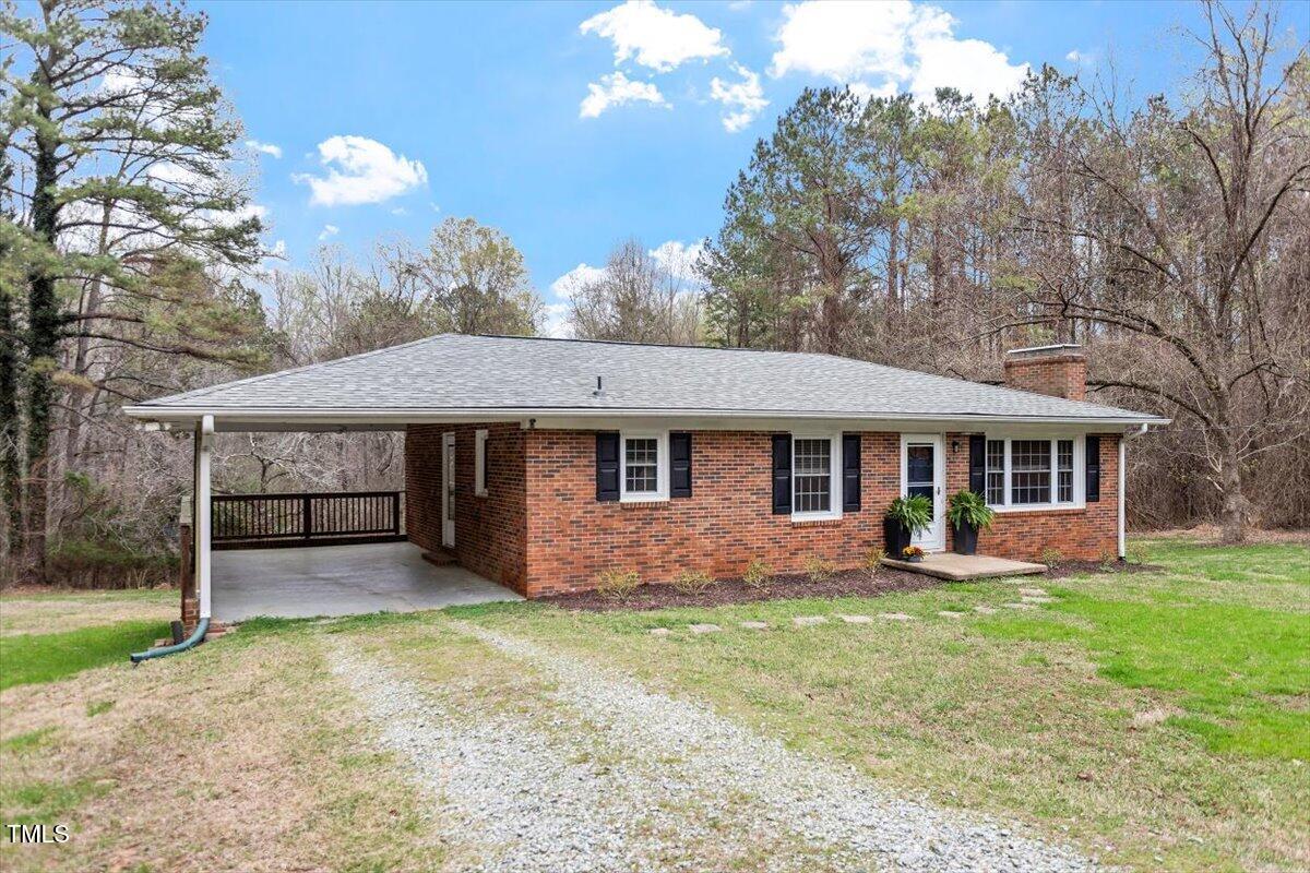 3402 Pat Tilley Road Bahama, NC 27503 - Photo 2 of 32 a front view of a house with garden