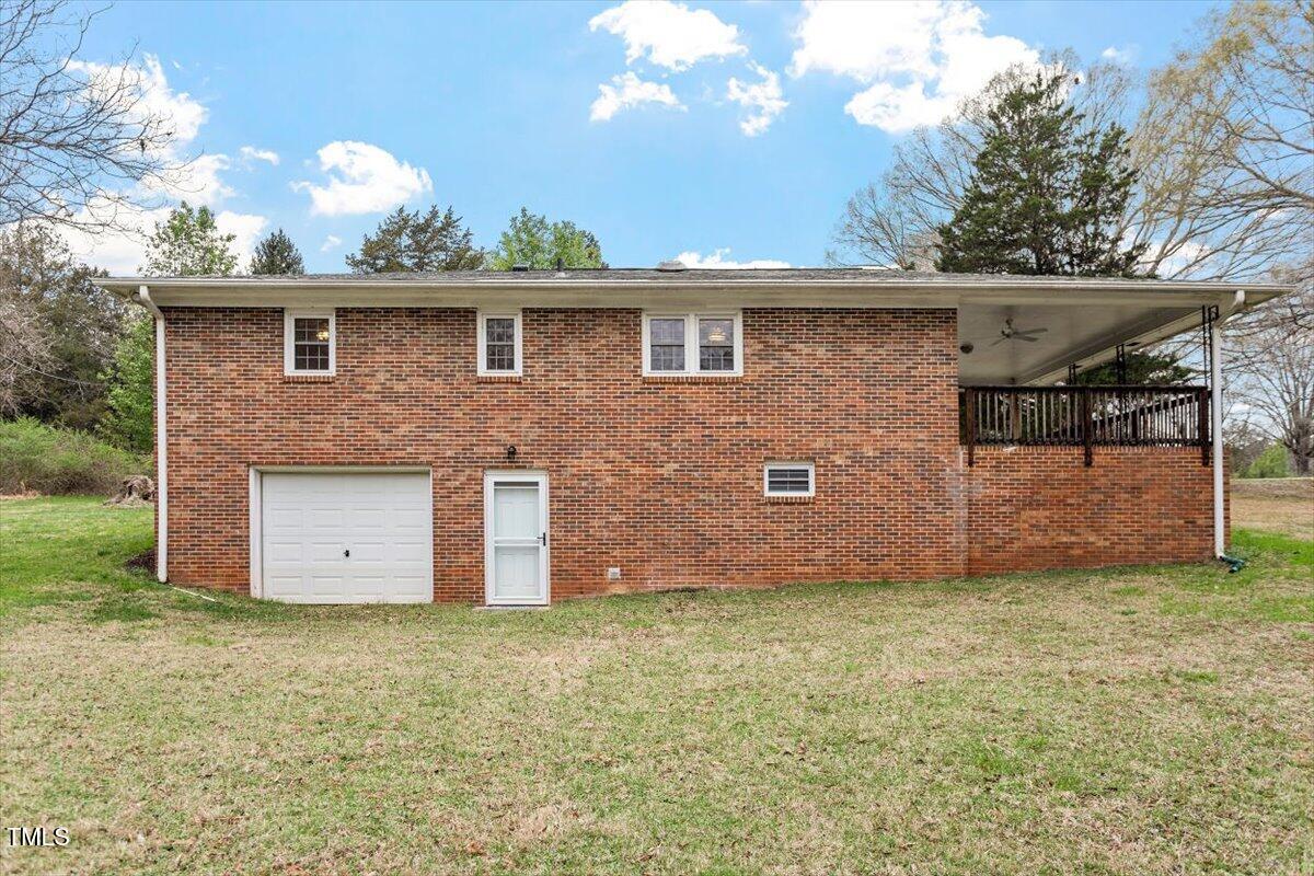 3402 Pat Tilley Road Bahama, NC 27503 - Photo 6 of 32 a view of a brick house with a yard