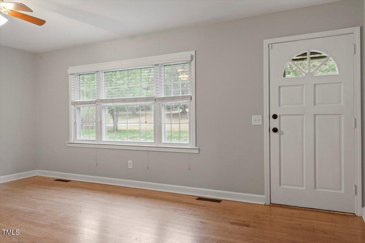 3402 Pat Tilley Road Bahama, NC 27503 - Photo 9 of 32 an empty room with wooden floor and windows