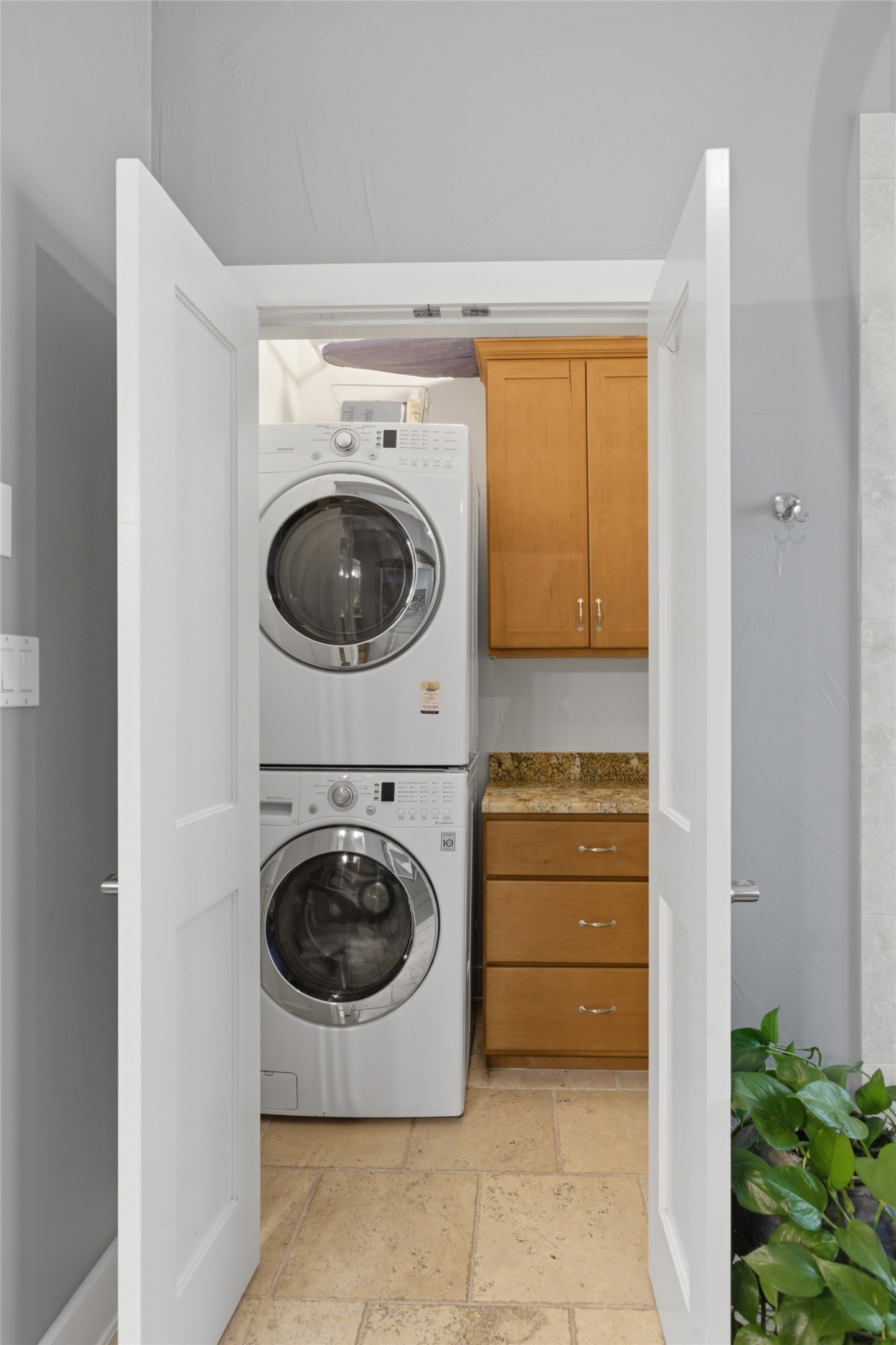 2008 Key West Cove Austin, TX 78746 - Photo 13 of 33 Laundry area with stacked washer and clothes dryer in primary bathroom