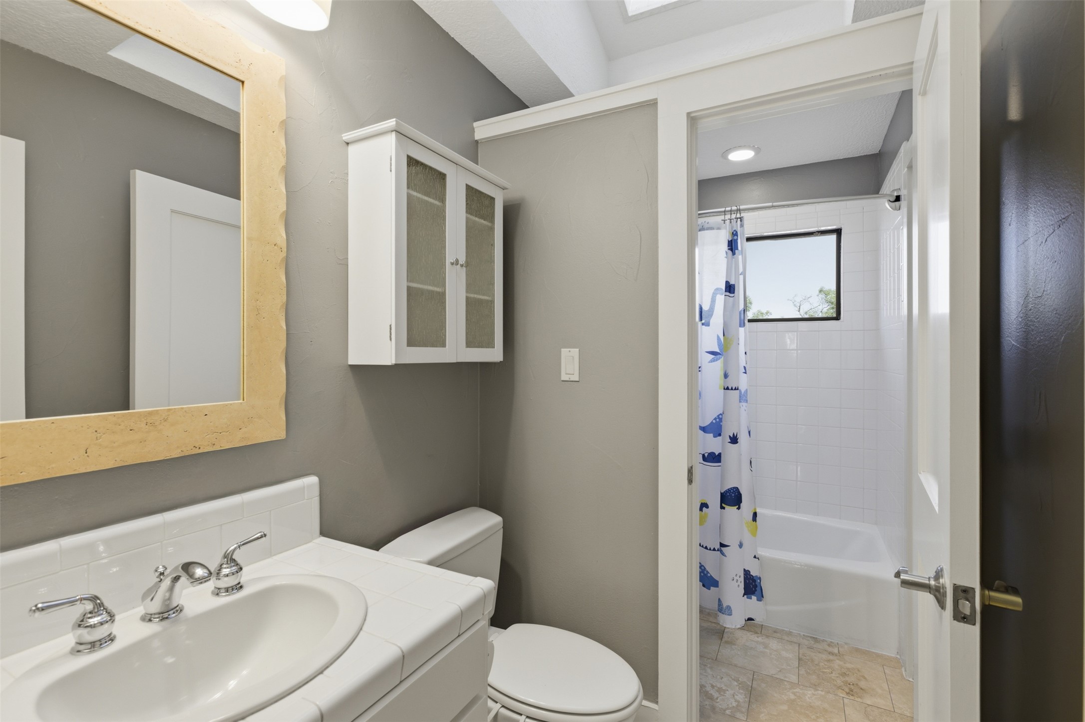 2008 Key West Cove Austin, TX 78746 - Photo 20 of 33 En-Suite Bathroom featuring vanity, shower / tub combo, and stone finish flooring