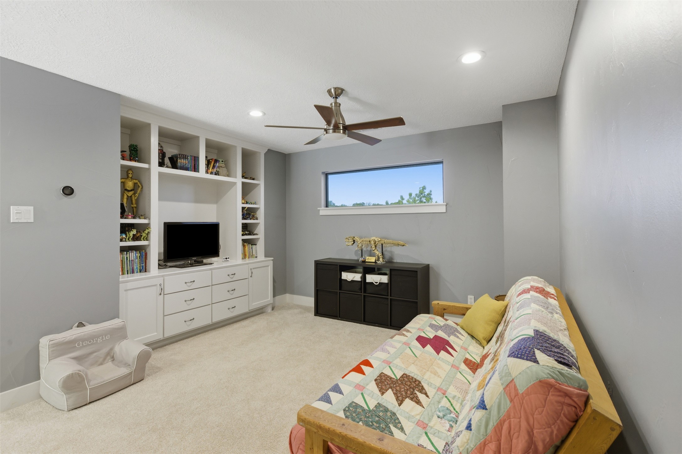 2008 Key West Cove Austin, TX 78746 - Photo 23 of 33 Sitting room with light carpet, ceiling fan, and recessed lighting and built in book shelves, drawers and media center.