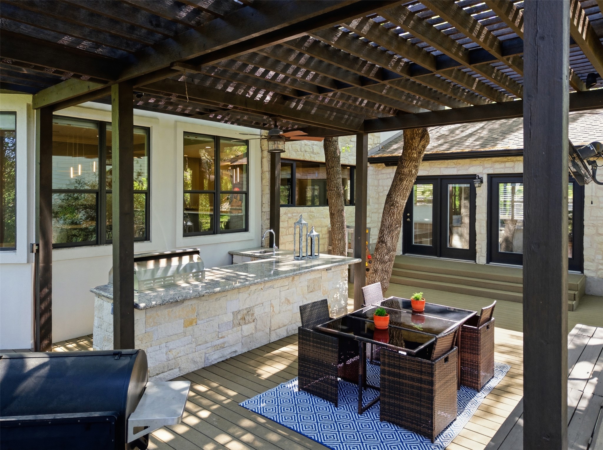 2008 Key West Cove Austin, TX 78746 - Photo 26 of 33 Deck featuring outdoor dining area, a pergola, and outdoor kitchen/grilling area