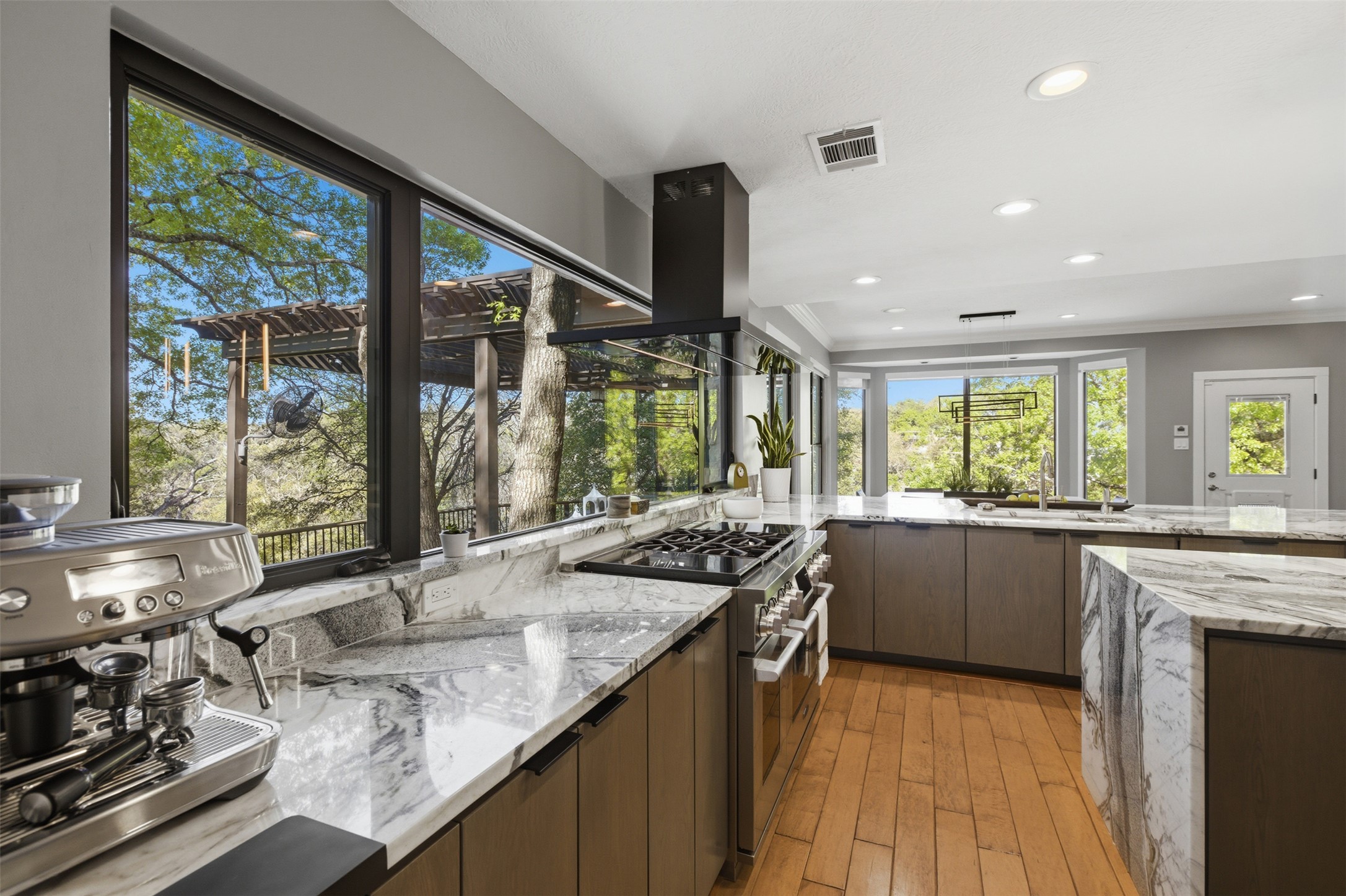 2008 Key West Cove Austin, TX 78746 - Photo 6 of 33 Kitchen featuring light wood finished floors, and a peninsula