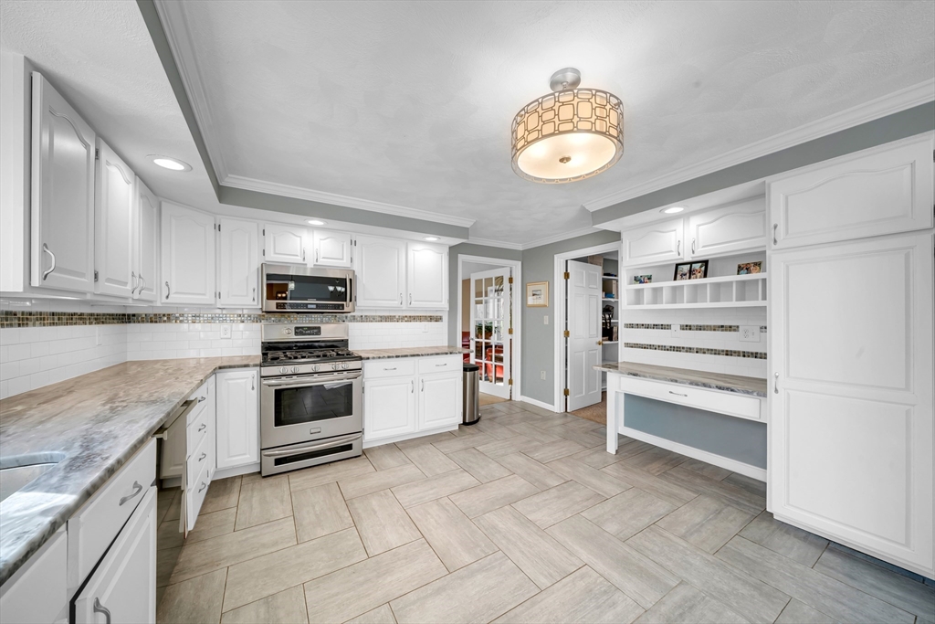 315 Candlestick Road North Andover, MA 01845 - Photo 18 of 42 a kitchen with stainless steel appliances a stove a sink and a refrigerator