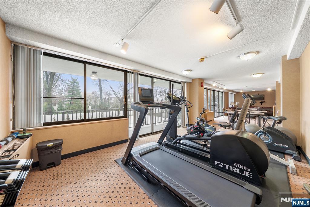 277 Prospect Avenue, Unit 14B Hackensack, NJ 07601 - Photo 20 of 23 a room with gym equipment and a large window