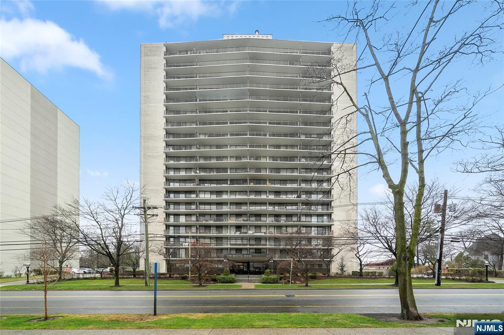 277 Prospect Avenue, Unit 14B Hackensack, NJ 07601 - Photo 23 of 23 a view of a tall building next to a yard