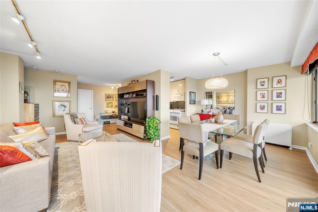 277 Prospect Avenue, Unit 14B Hackensack, NJ 07601 - Photo 4 of 23 a living room with furniture and a wooden floor