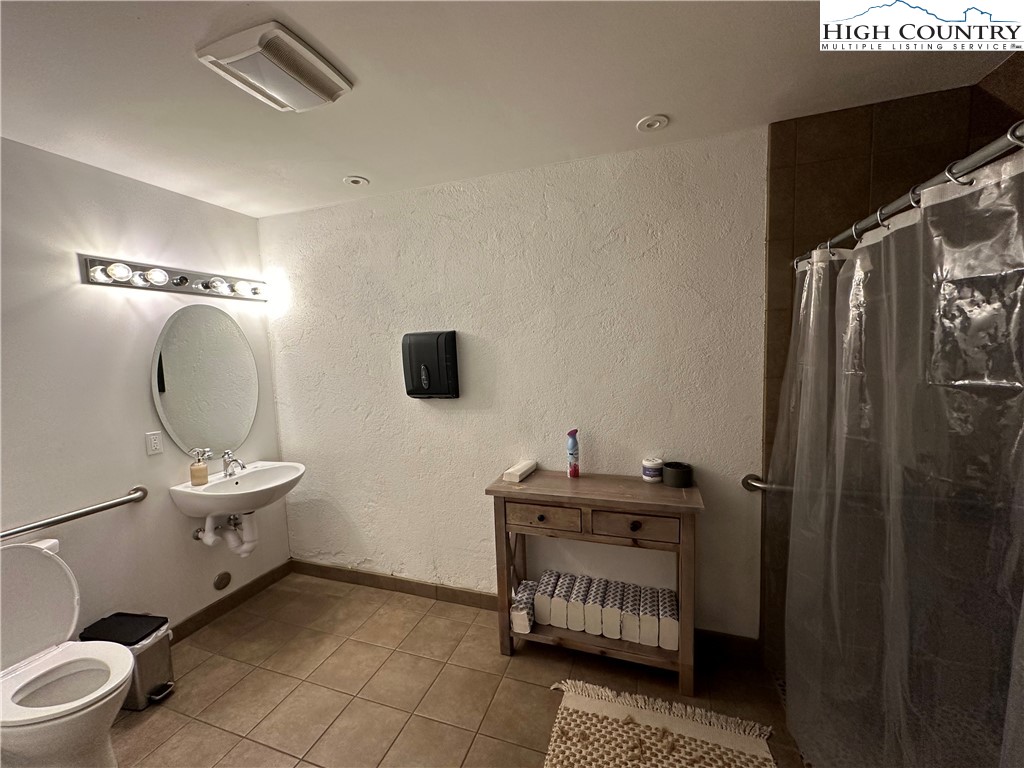 164 Depot Street Boone, NC 28607 - Photo 15 of 24 a bathroom with a toilet a sink and mirror