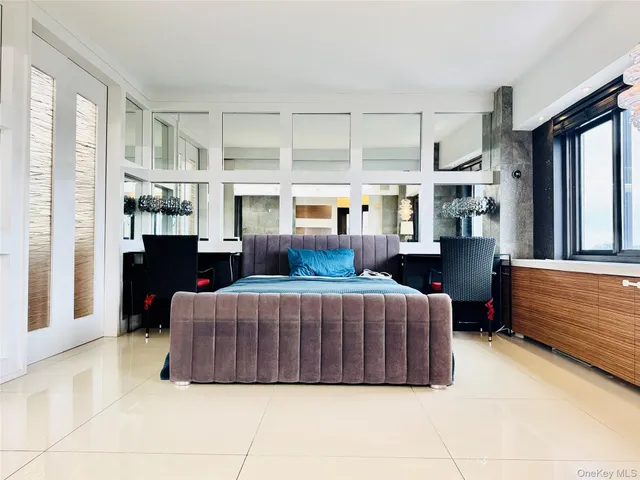 a living room with furniture a large window and dresser