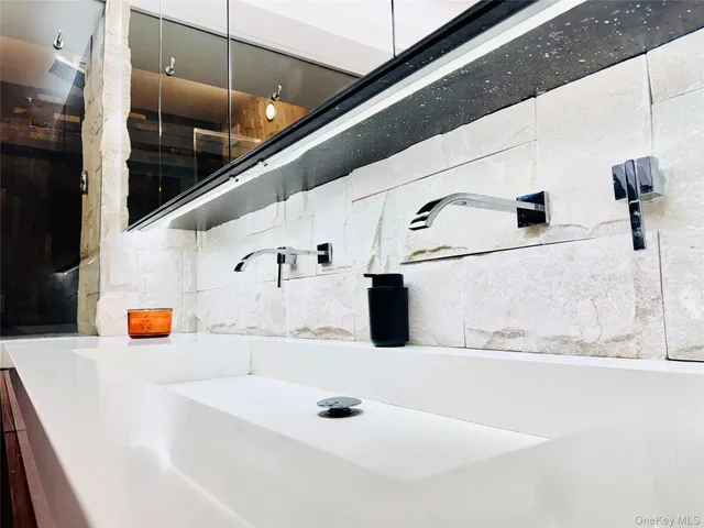 a bathroom with a sink and a mirror