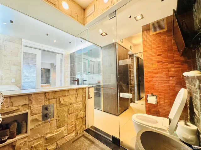a bathroom with a sink mirror vanity and bathtub