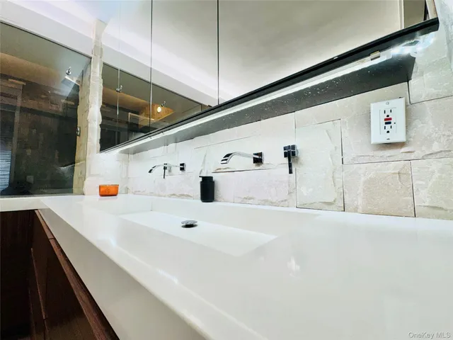 a bathroom with a tub a sink and shower