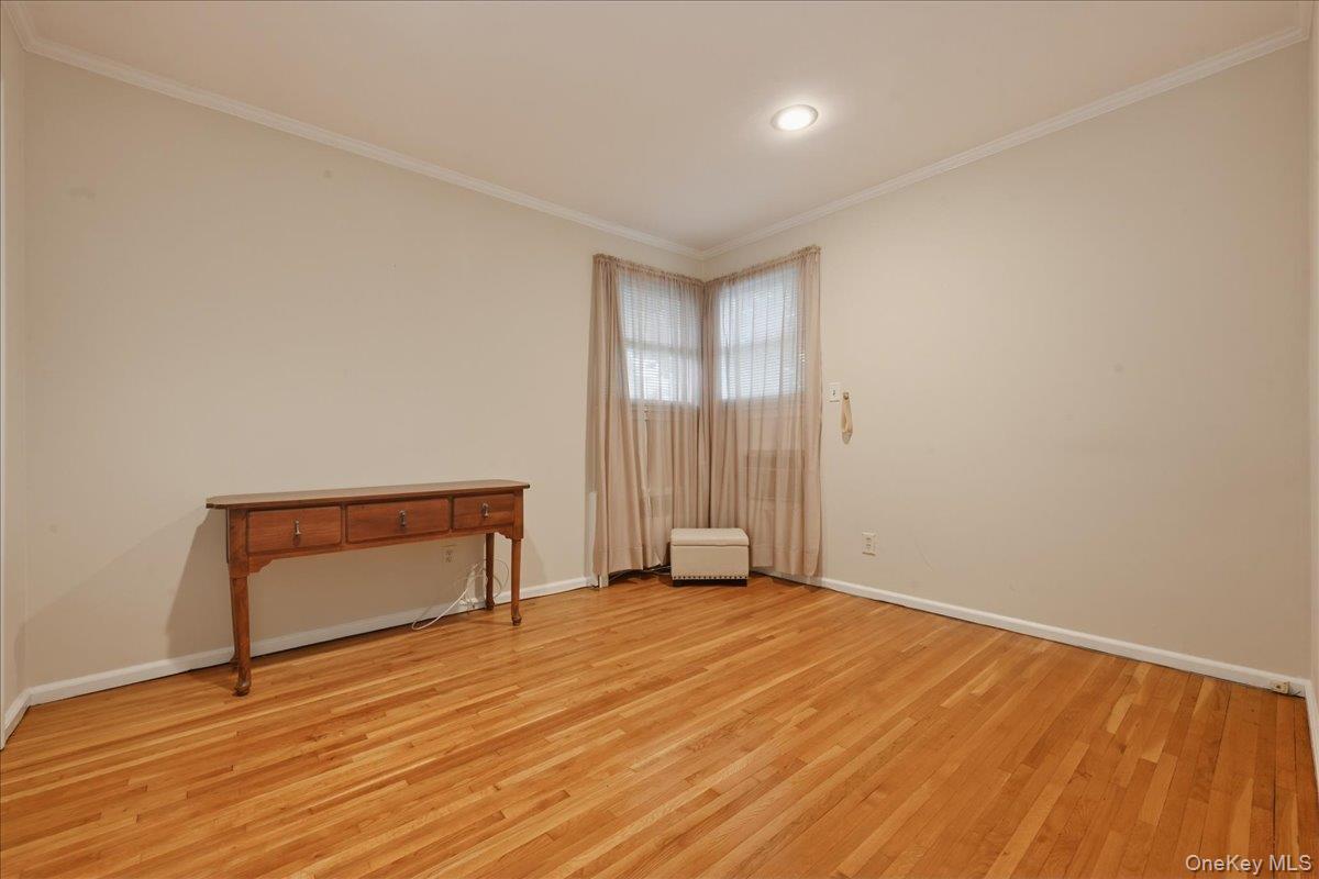 17 Avon Road Farmingdale, NY 11735 - Photo 22 of 46 a view of an empty room with wooden floor and a window