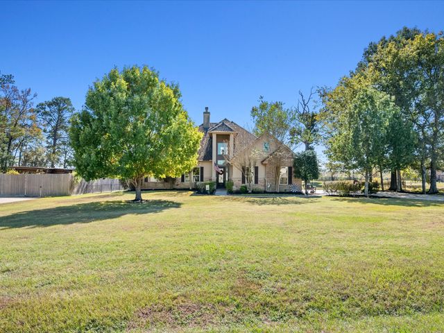 a front view of house with yard and trees
