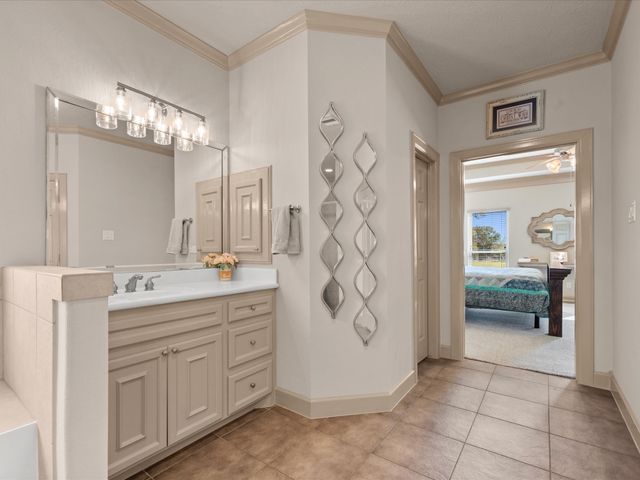 a spacious bathroom with a granite countertop sink a mirror and a shower