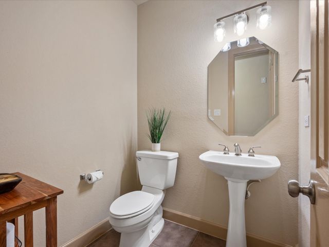 an entryway with a window and a chandelier fan